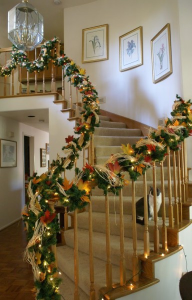 stair bannister decorated for thanksgiving and christmas