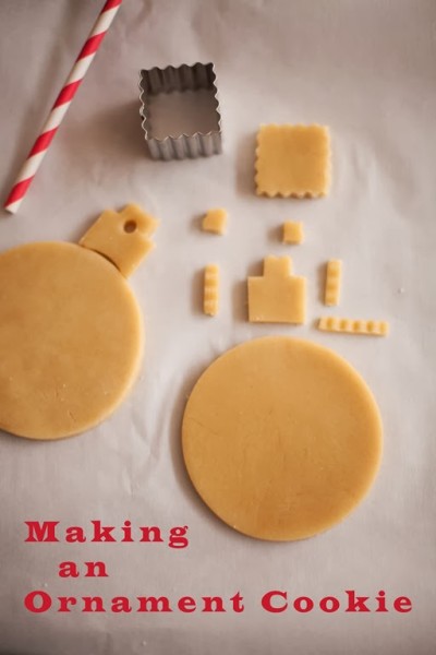 decorated pink christmas ornament cookies with fondnt snowflake